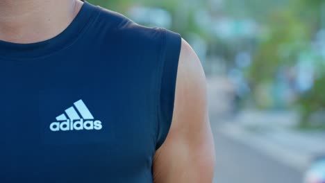 Close-up-of-a-man-stretching-the-muscles-to-prepare-for-a-morning-workout-at-the-beach