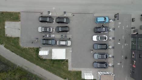 Drone-shot-of-a-charging-station-filled-with-electric-cars