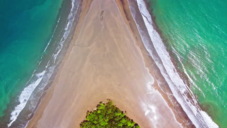 Aerial-drone-footage-revealing-a-beach-shaped-like-a-whale's-tail-in-Ballena-Marine-National-Park,-Costa-Rica
