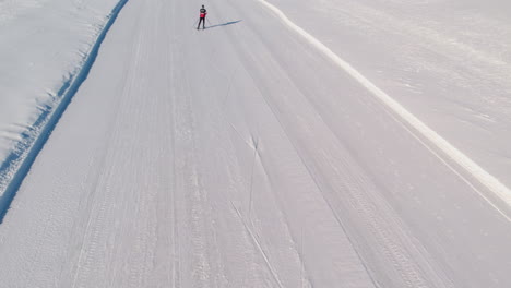 Skier-skiing-on-a-frozen-lake-in-the-winter-on-a-sunny-day