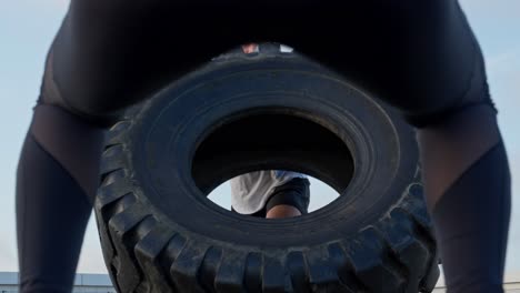 The-man-doing-the-tire-flip-exercise-with-an-impressive-facial-expression