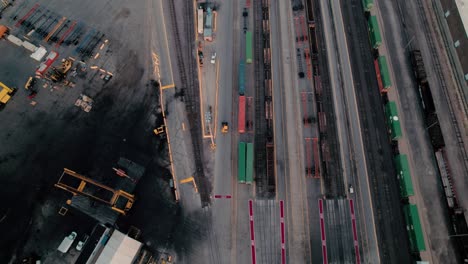 yellow-yard-jockey-truck-driving-in-a-Intermodal-Terminal-Rail-road-with-yard-full-of-containers