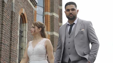 Beautiful-wedding-couple-walking-next-to-church