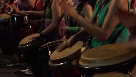 Close-up-of-drums,-feminist-women-beat-on-them,-perform-in-abortion-rally