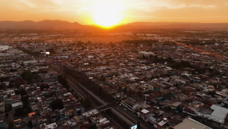 Aerial-view-backwards-over-the-Plaza-de-Toros-arena,-sunset-in-Aguascalientes,-Mexico