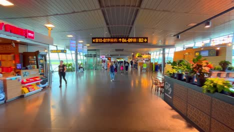 Cinematic-dolly-forward-though-international-airport-terminal-with-shops