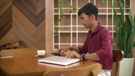 Business-man-sitting-in-a-cafe-having-a-break-and-drinking-a-glass-of-coffee