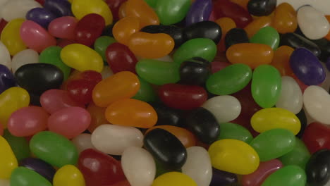 Macro-close-up:-Sweet-colourful-Jelly-bean-candies-rotate-full-frame
