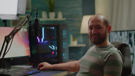 Streamer-man-looking-at-camera-smiling-while-streaming-videogames