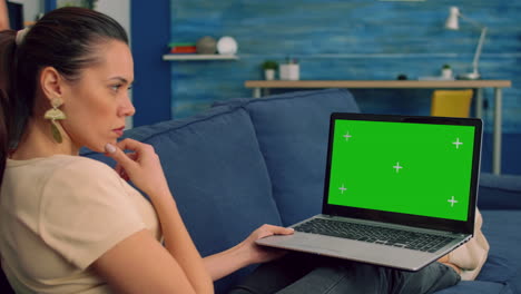 Business-woman-working-on-laptop-computer-with-mock-up-green-screen