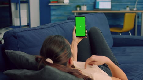 Casual-woman-holding-smartphone-with-mock-up-green-screen