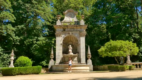 Tourist-near-the-fountain-in-Sanctuary-of-Our-Lady-of-Remedies-in-Lamego,-Portugal