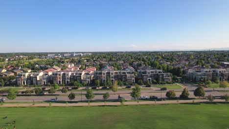 Aerial-Drone-flying-parallel-to-houses-in-the-Stapleton-Suburb-of-the-City-of-Denver,-Colorado-during-golden-hour-in-Summer