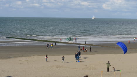 Person-practicing-kitesurfing-on-beach-sand,-Oostduinkerke,-Belgium