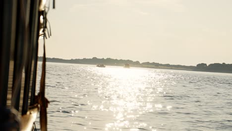 Silhouette-of-passenger-smoking-at-side-of-boat