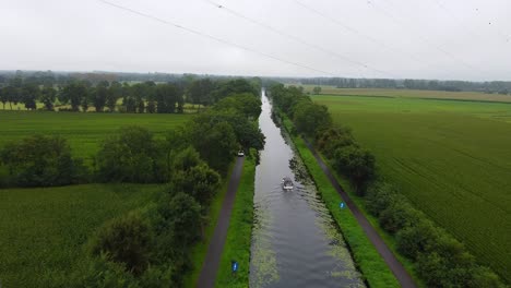 Boat-navigating-through-the-Beverlo-canal-aerial-view-with-surrounding-agricultural-landscapes