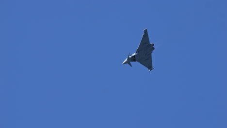 Eurofighter-typhoon-show-up-in-mountain-region-of-Switzerland,-handheld-view