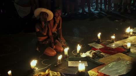 Female-feminist-show-support-during-memorial-with-candles-of-gender-violence-victims