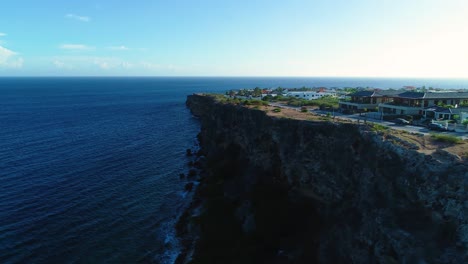 Aerial-orbit-swings-out-from-luxury-ocean-view-homes-in-curacao-caribbean-cliffs