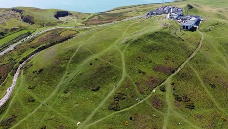 Breathtaking-drone-clip-closing-in-on-the-Great-Orme-cable-car-and-summit-station-by-Llandudno,-Wales