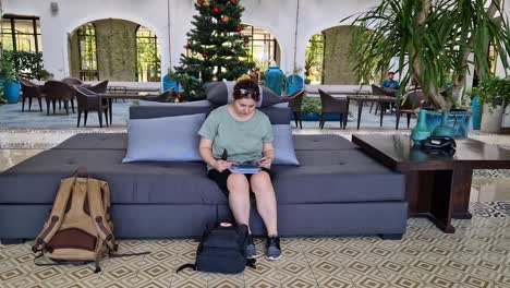 Woman-sits-in-The-elegant-lobby-of-Lasenta-Boutique-Hotel-in-Hoi-An,-Vietnam