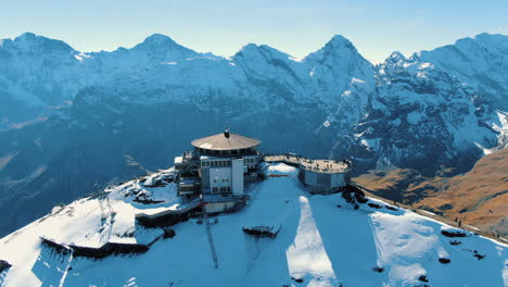aerial-view-of-the-Schilthorn-piz-Gloria:-circling-flight-over-the-station-in-an-autumnal-landscape-on-a-sunny-day