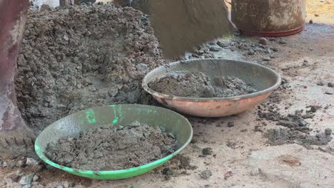 Indian-workers-doing-construction-work-manually-on-floor-using-a-shovel-in-India