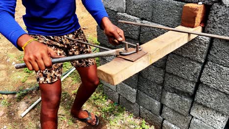 Worker-using-pliers-for-Bundle-of-steel-rebar-for-building-structures-beams-in-india