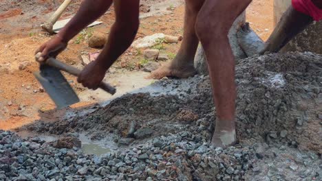 Indian-labour-mixing-cement-and-water-manually-on-floor-using-a-shovel