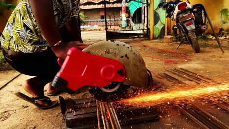 Installer-cuts-metal-pipe-in-India
