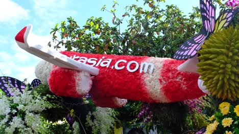 A-flower-decorated-airline-showcasing-their-aircraft-on-parade-during-the-street-festival