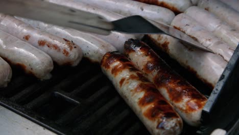 Pork-Sausages-Turned-Over-on-Hot-BBQ-in-Summer