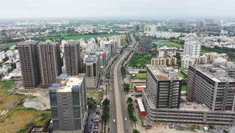 Aerial-cinematic-view-of-ring-road-passing-through-Rajkot-city,-aerial-drone-camera-showing-entire-Rajkot-city