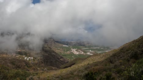 Clouds-rolling-by-above-the-steep-hills-and-windy-roads-on-the-North-Coast-of-Tenerife,-Canary-Islands--Tripod-shot