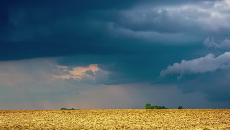 Timelapse-shot-of-dark-rain-clouds-moving-over-rural-countryside-on-a-cloudy-day