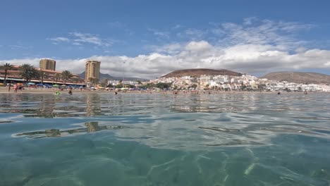 Gente-Disfrutando-De-Un-Día-De-Playa-En-La-Isla-Tropical-De-Tenerife-Con-Hermosas-Aguas-Turquesas---Toma-Estática