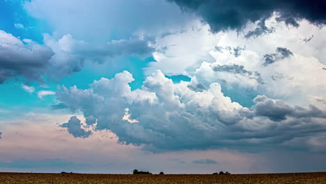 Timelapse-shot-of-white-and-dark-rain-clouds-moving-along-rural-countryside-on-a-cloudy-day