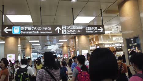 People-Walk-Around-Shinkansen-Train-Central-Station,-Inside-Kyoto-Japan,-Metro-Transportation-in-Vintage-Colors-at-Japanese-Summer