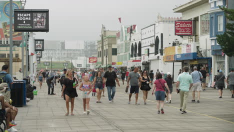 People-Walk-on-Atlantic-City,-New-Jersey-Boardwalk-on-Overcast-Summer-Morning