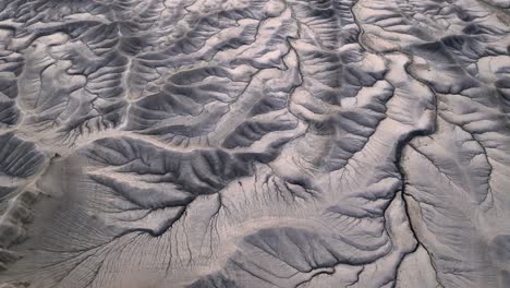 Huge-cracks-in-grey-mountain-surface,-abstract-dramatic-nature-panorama,-aerial