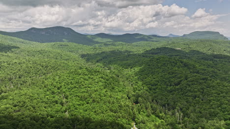 Highlands-North-Carolina-Aerial-v19-panoramic-panning-view-drone-flyover-Flat-mountain-farm-capturing-serene-landscape-of-lush-green-forests-and-mountainscape---Shot-with-Mavic-3-Cine---July-2022