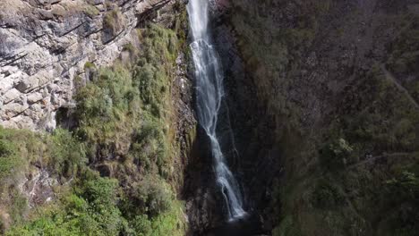 Drone-captured-view-of-Candela-Fasso-waterfall,-showcasing-its-beauty-from-an-overhead-perspective