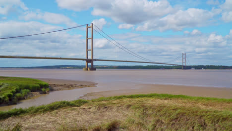 Aerial-drone-video-showcases-Humber-Bridge:-12th-largest-suspension-span-globally,-over-River-Humber,-connecting-Lincolnshire-to-Humberside-with-traffic