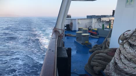 Rear-deck-of-a-ferry-sailing-between-greek-islands,-leaving-the-port-and-reaching-his-next-destination