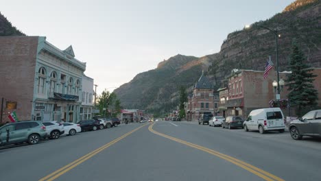 Looking-Down-Main-Street-In-Ouray,-Colorado-During-Golden-Hour-With-San-Juan-Mountains-In-The-Background