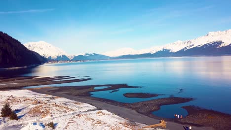4K-Drone-Video-of-Seward,-Alaska-Beach-and-Surrounding-Snow-Covered-Mountains-on-Snowy-Winter-Day