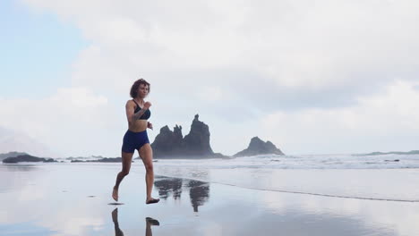 Rise-and-Run:-Slow-Motion-Beachside-Jog-of-an-Athletic-Woman-Sculpting-Curves