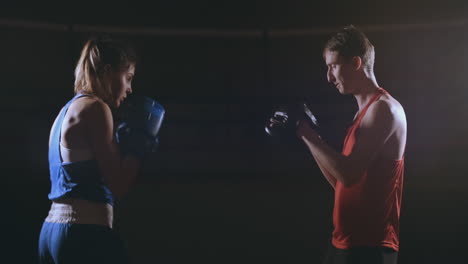 Woman-Punches-The-Focus-Mitts-In-The-Boxing-Gym