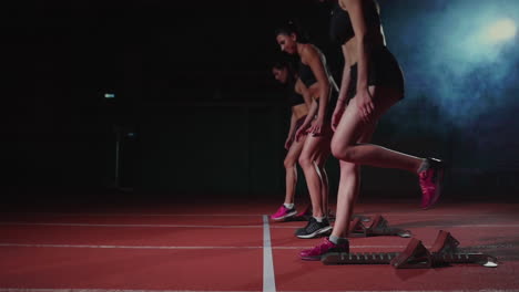 Female-athletes-warming-up-at-running-track-before-a-race.-In-slow-motion
