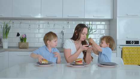 Children-in-the-kitchen-feed-their-mom-with-self-cooked-diet-burgers